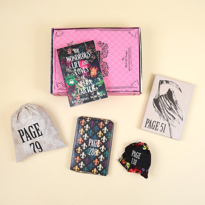 A paperback edition of The Wondrous Life and Loves of Nella Carter stands on a pink OUABC box. In front of the box are four wrapped gifts labeled with page numbers.